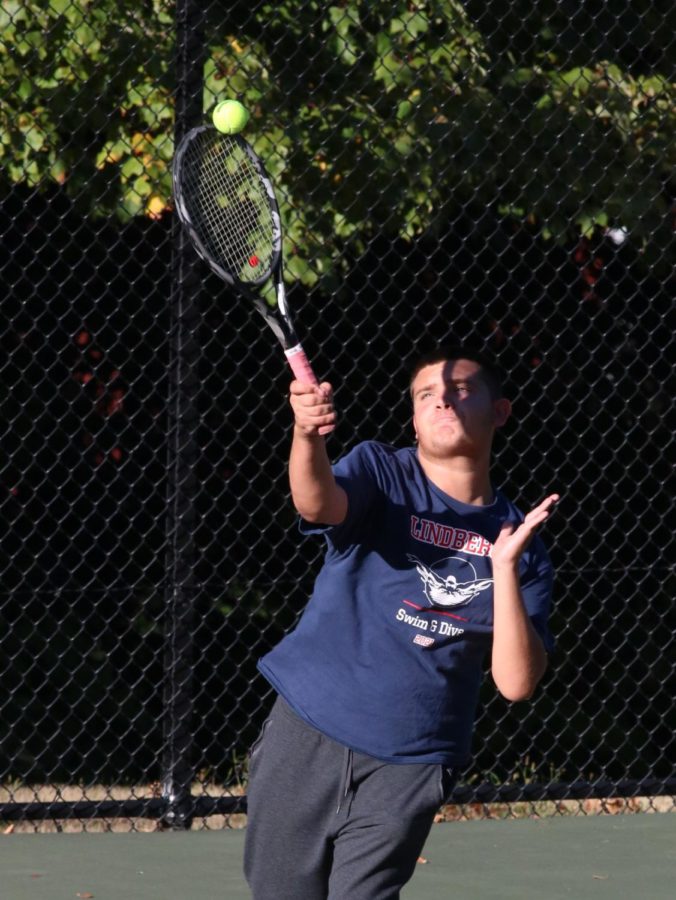 Andrew Carlisle serves a ball during their doubles match with teammate Spencer Edwards against Renton. They won 8-6, 6-3.