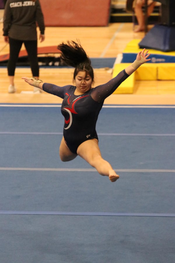 Emi Hirano performs on the floor exercise during their meet against Highline and Sammamish.