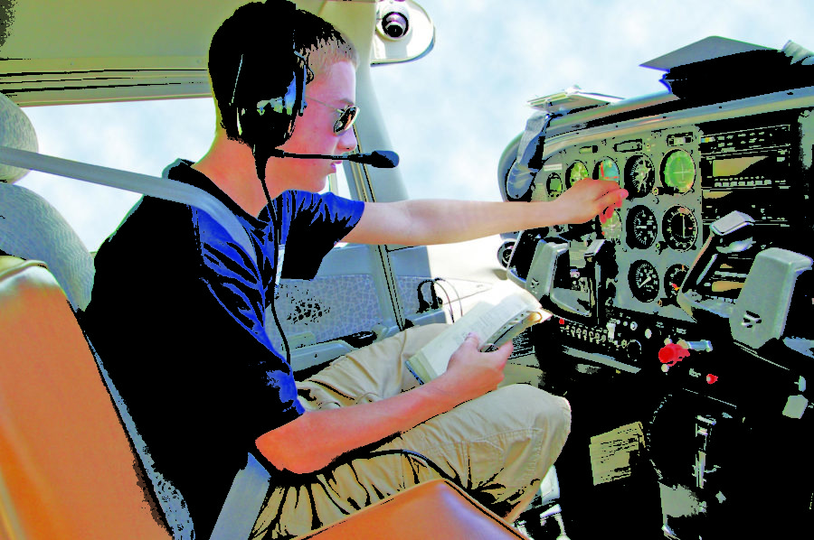 A+Civil+Air+Patrol+cadet+checks+his+Cessnas+instrument+panel+before+taking+off+during+a+flight+academy+session.