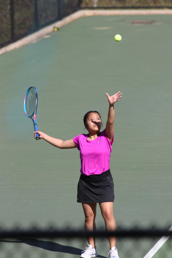 Senior Carlota Laygo serves during a recent match in girls singles.