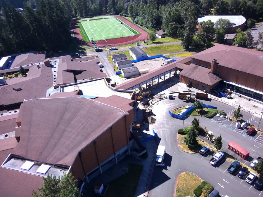 A drone flies over the lower parking showing the football field near completion and crews working at the front entrance on July 19. 